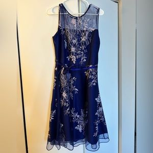 J. Taylor navy dress with a floral embroidered tulle overlay and a satin belt